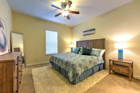 A bedroom with a bed, dresser, and ceiling fan at Alaqua, Florida, 32258